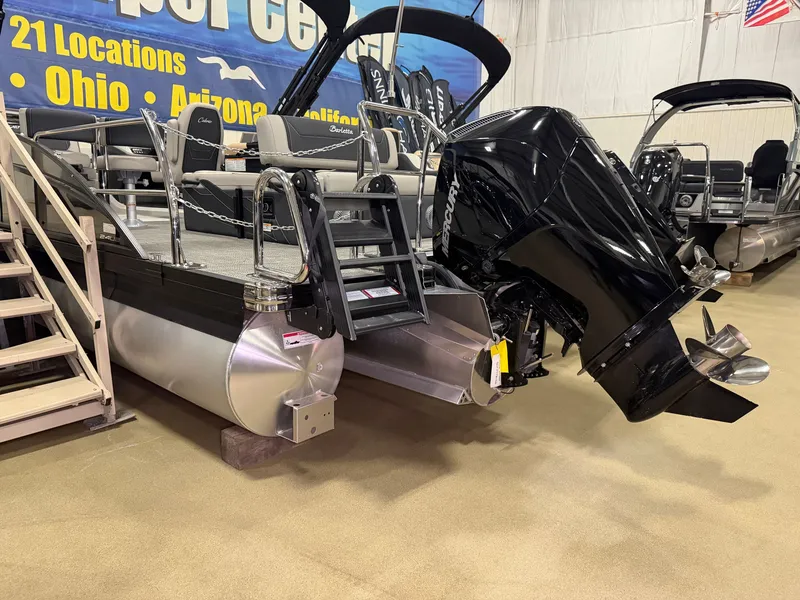 Slide: The Image of A Barletta Cabrio 24 UE pontoon boat with a powerful outboard motor in a showroom. - 40