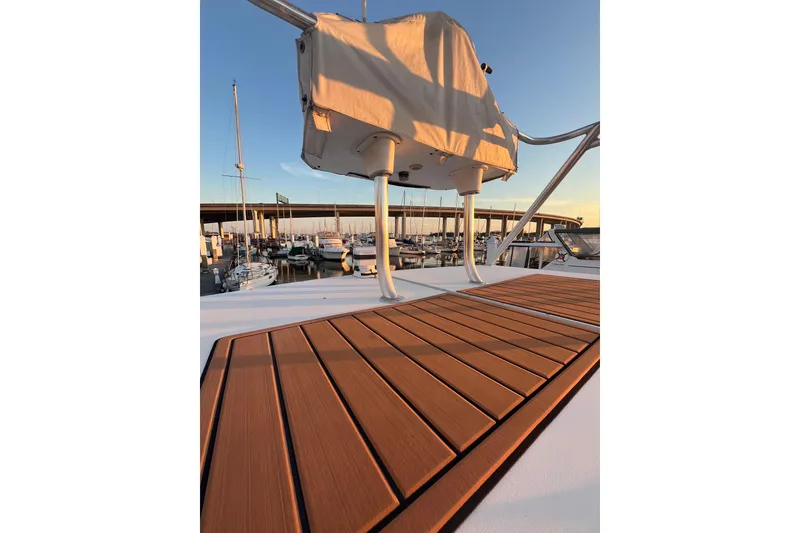 Slide: The Image of 2002 Out Island 38 Express Fisherman boat deck at sunset in marina. - 15