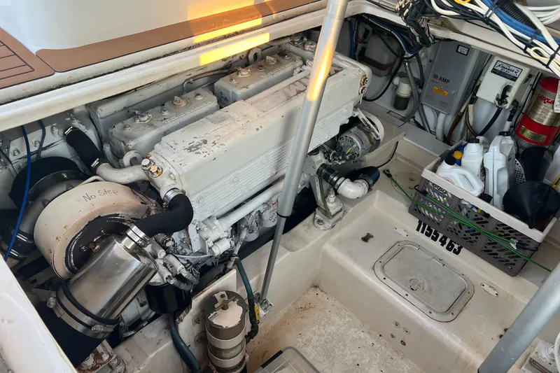 Slide: The Image of Engine compartment of a 2002 Out Island 38 Express Fisherman with maintenance supplies. - 18