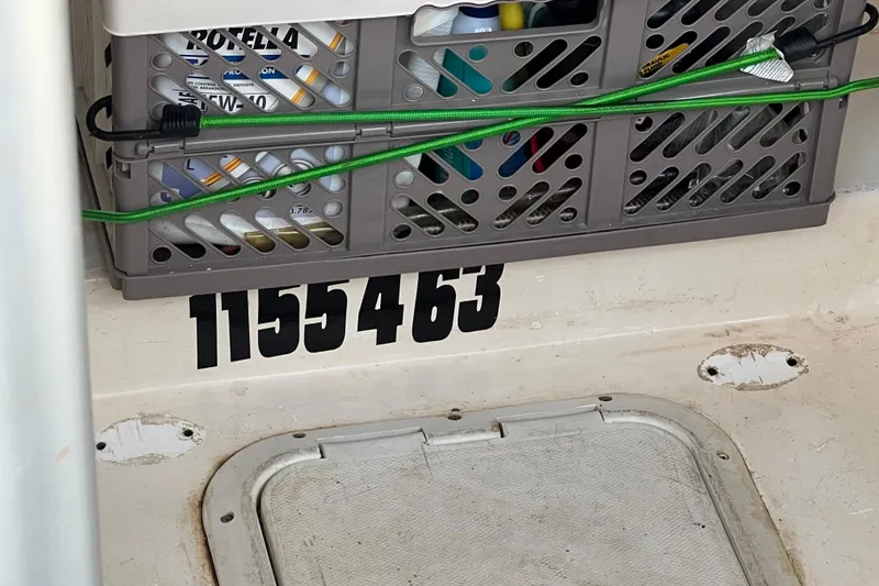 Slide: The Image of Storage crate on 2002 Out Island 38 Express Fisherman boat with visible registration number. - 19