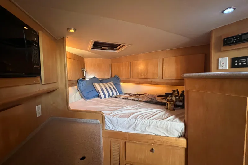 Slide: The Image of Interior cabin of 2002 Out Island 38 Express Fisherman with cozy bed and wooden cabinetry. - 24