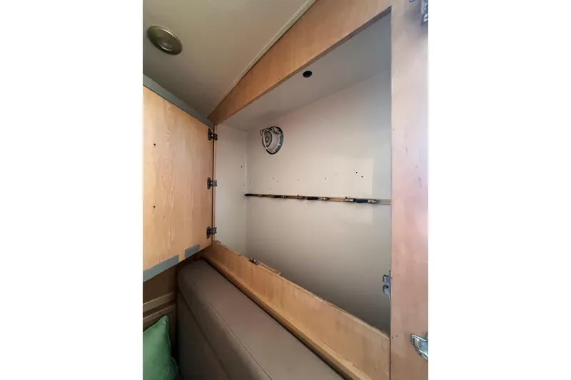 Slide: The Image of Empty wooden storage cabinet inside 2002 Out Island 38 Express Fisherman boat. - 28