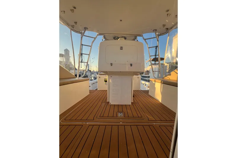 Slide: The Image of 2002 Out Island 38 Express Fisherman boat deck with wooden flooring and seating area. - 29