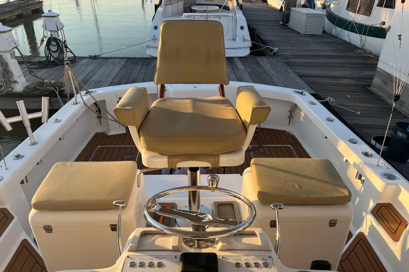 Slide: The Image of 2002 Out Island 38 Express Fisherman boat interior with helm and cushioned seating. - 30