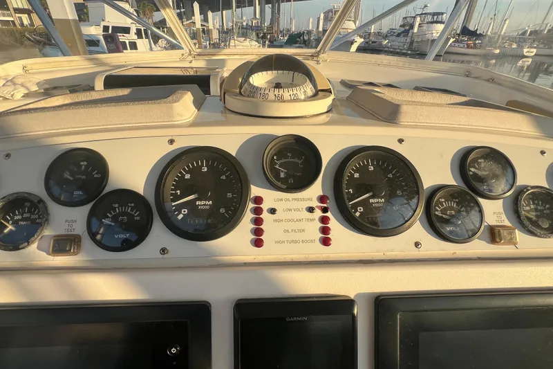 Slide: The Image of Dashboard of a 2002 Out Island 38 Express Fisherman boat with gauges and compass. - 34