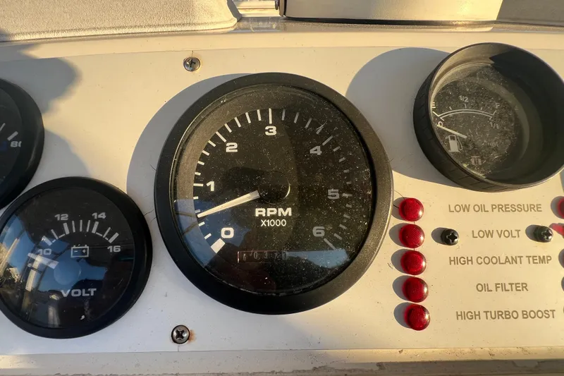 Slide: The Image of Instrument panel of a 2002 Out Island 38 Express Fisherman boat, showing RPM and voltage gauges. - 36