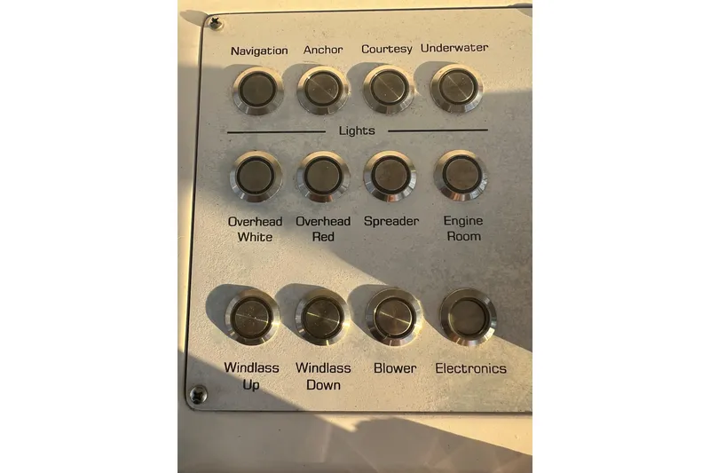 Slide: The Image of Control panel of a 2002 Out Island 38 Express Fisherman boat with labeled buttons. - 37