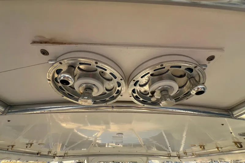 Slide: The Image of Ceiling-mounted fishing reel holders on a 2002 Out Island 38 Express Fisherman boat. - 39