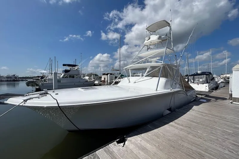 Slide: The Image of 2002 Out Island 38 Express Fisherman docked at marina under blue sky. - 4