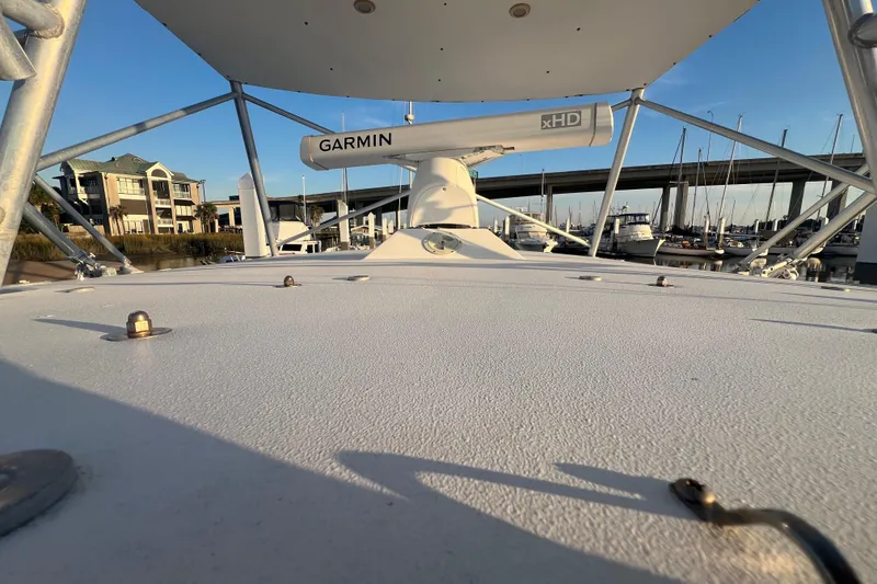 Slide: The Image of 2002 Out Island 38 Express Fisherman boat with Garmin radar, docked near marina and bridge. - 40