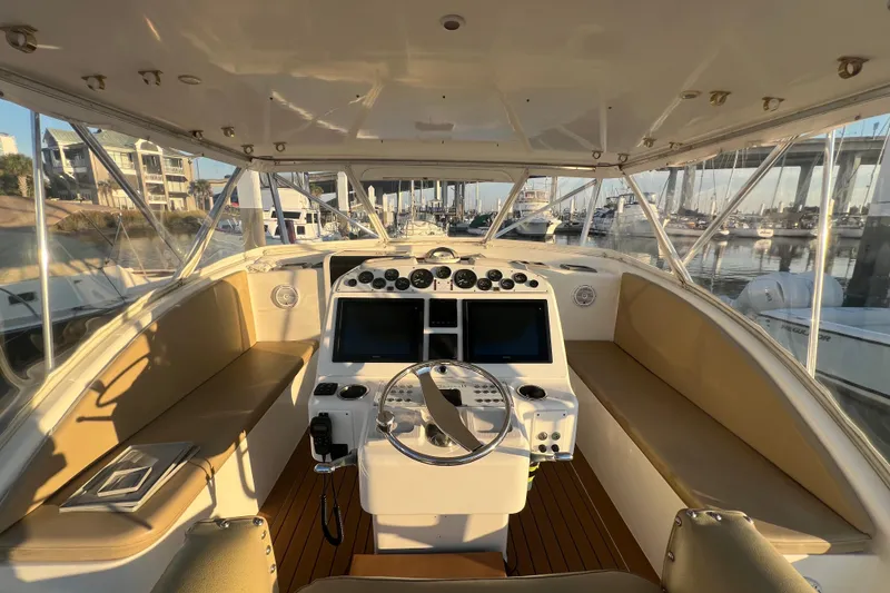 Slide: The Image of 2002 Out Island 38 Express Fisherman boat interior with helm, dual screens, and seating. - 41