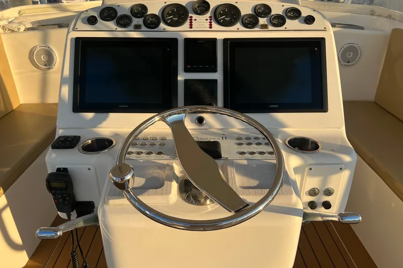 Slide: The Image of Helm of 2002 Out Island 38 Express Fisherman with dual screens and gauges. - 42