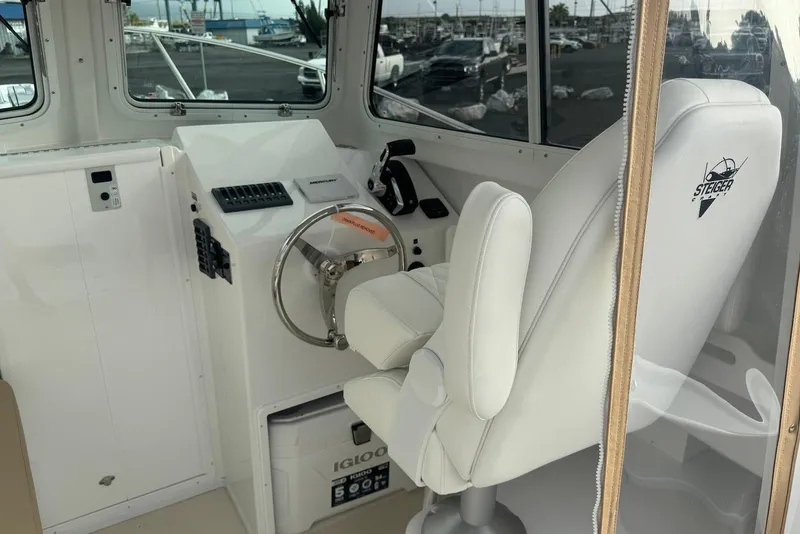 Slide: The Image of 2026 Steiger Craft 21 MIAMI boat interior with steering wheel and captain's chair. - 11