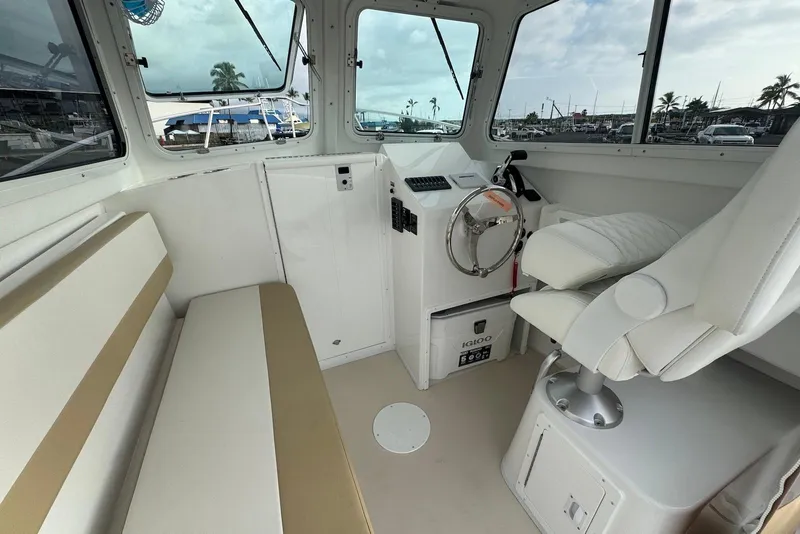 Slide: The Image of Interior of 2026 Steiger Craft 21 MIAMI boat with helm and seating area. - 12