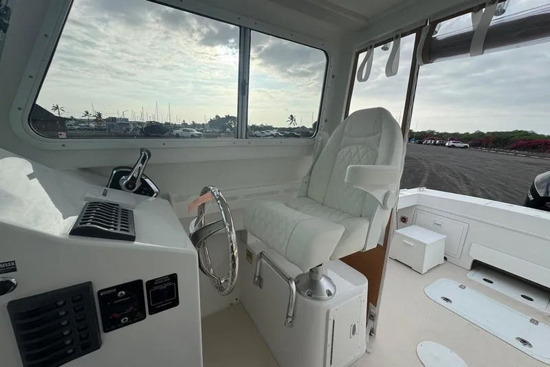 Slide: The Image of 2026 Steiger Craft 21 MIAMI boat interior with captain's chair and steering wheel. - 13