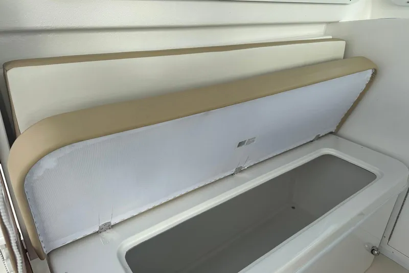 Slide: The Image of 2026 Steiger Craft 21 MIAMI boat storage compartment with cushioned seat. - 16