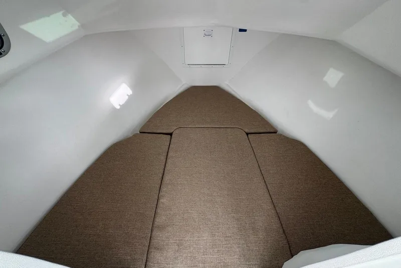 Slide: The Image of 2026 Steiger Craft 21 MIAMI cabin interior with brown cushions and white walls. - 17