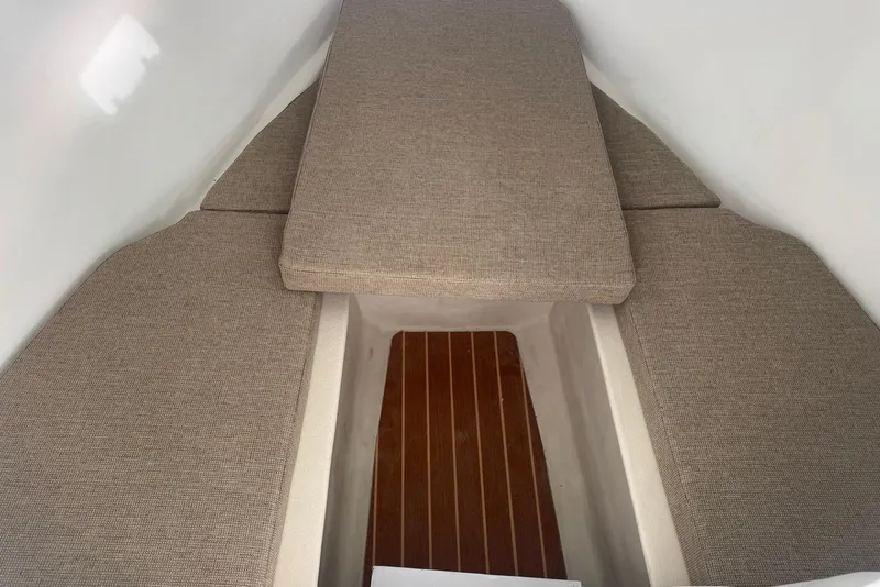 Slide: The Image of 2026 Steiger Craft 21 MIAMI cabin interior with cushioned seating and wooden flooring. - 18