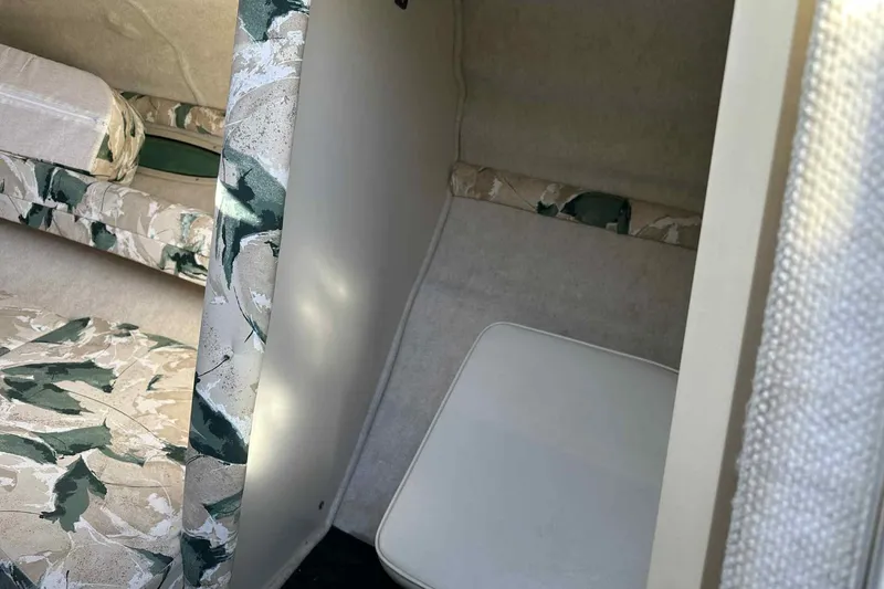 Slide: The Image of 2000 Sea Ray 215 Express Cruiser cabin interior with patterned upholstery. - 11