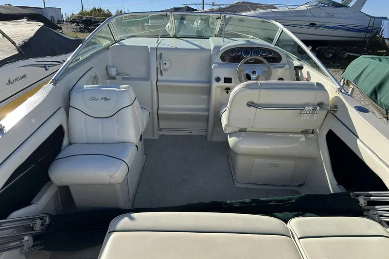 Slide: The Image of 2000 Sea Ray 215 Express Cruiser interior with steering wheel and seating. - 16