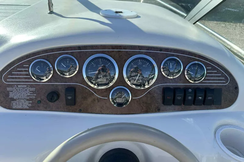 Slide: The Image of Dashboard of a 2000 Sea Ray 215 Express Cruiser with gauges and controls. - 17