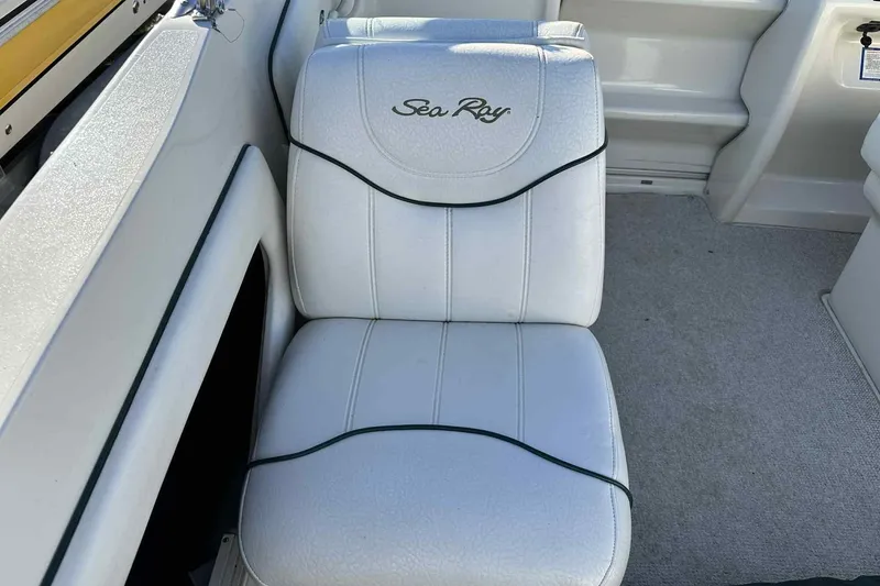 Slide: The Image of White leather seat on 2000 Sea Ray 215 Express Cruiser boat interior. - 4