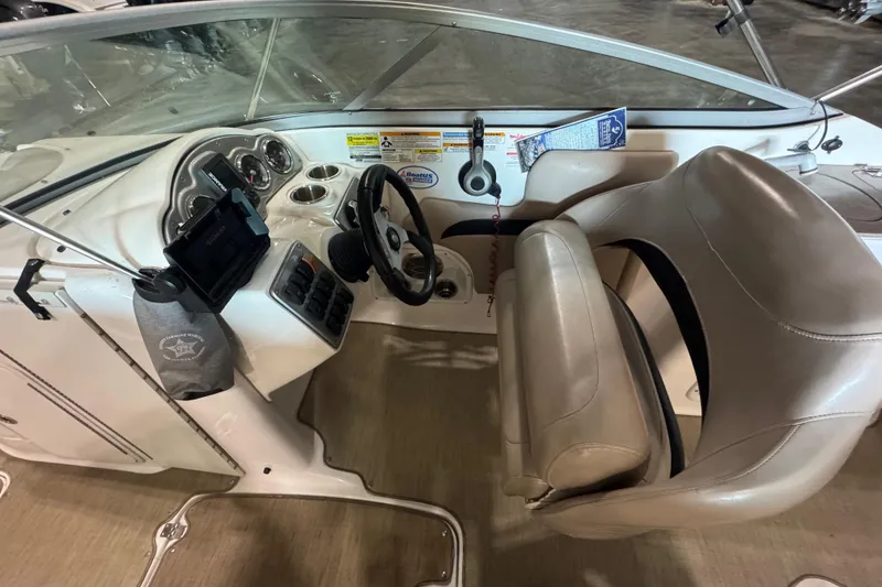 Slide: The Image of 2014 Hurricane SunDeck 2400 OB boat interior with steering wheel and dashboard controls. - 10