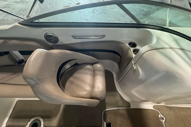 Slide: The Image of 2014 Hurricane SunDeck 2400 OB interior with beige seating and cup holders. - 12