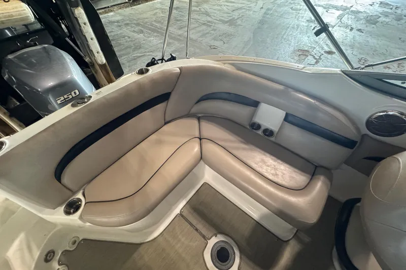 Slide: The Image of 2014 Hurricane SunDeck 2400 OB boat interior with beige seating and Yamaha 250 outboard motor. - 13
