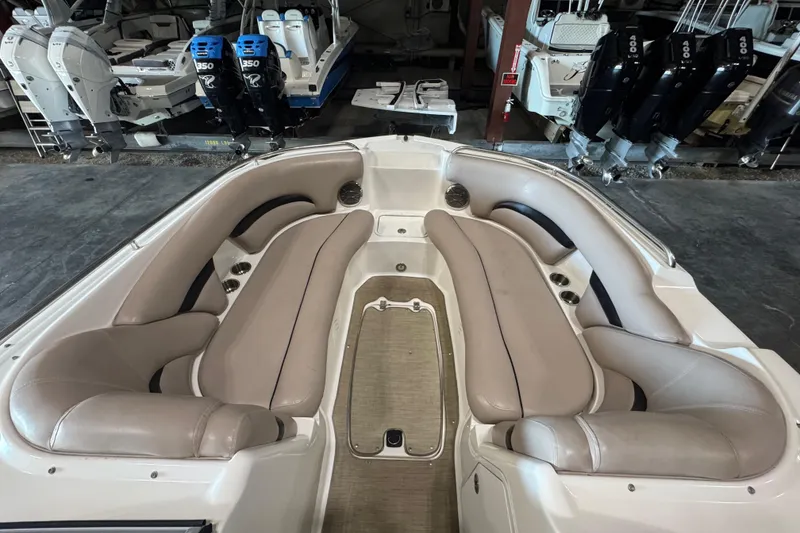 Slide: The Image of 2014 Hurricane SunDeck 2400 OB boat interior with beige seating and cup holders. - 15