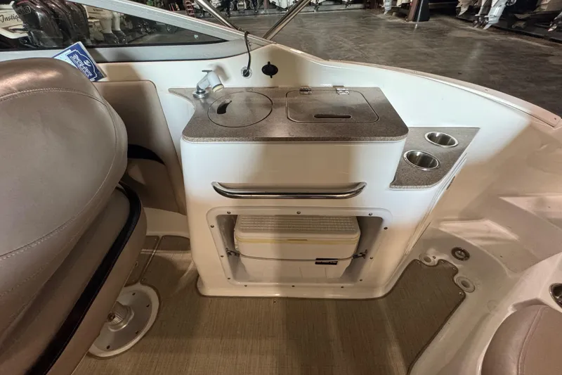 Slide: The Image of 2014 Hurricane SunDeck 2400 OB boat interior with sink, storage, and cup holders. - 18