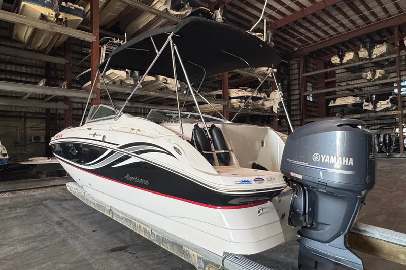 Slide: The Image of 2014 Hurricane SunDeck 2400 OB boat with Yamaha outboard motor in storage facility. - 4