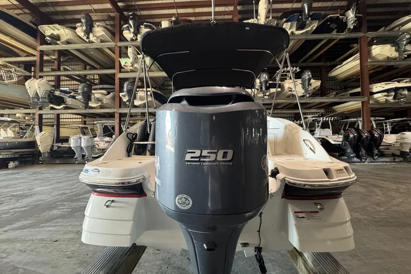 Slide: The Image of 2014 Hurricane SunDeck 2400 OB boat with Yamaha 250 engine in storage facility. - 7
