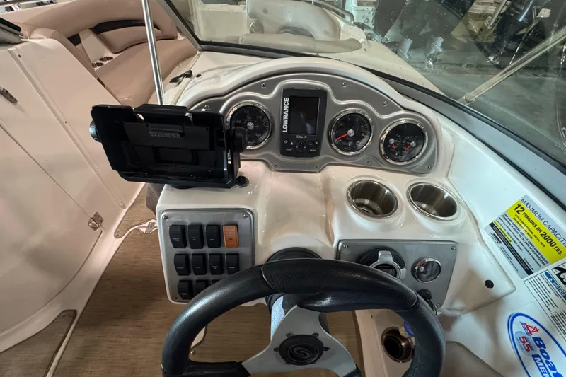 Slide: The Image of Dashboard of a 2014 Hurricane SunDeck 2400 OB boat with gauges and controls. - 9