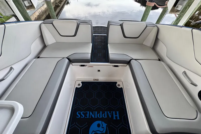 Slide: The Image of 2023 Yamaha Boats AR250 interior with sleek seating and custom flooring design. - 19