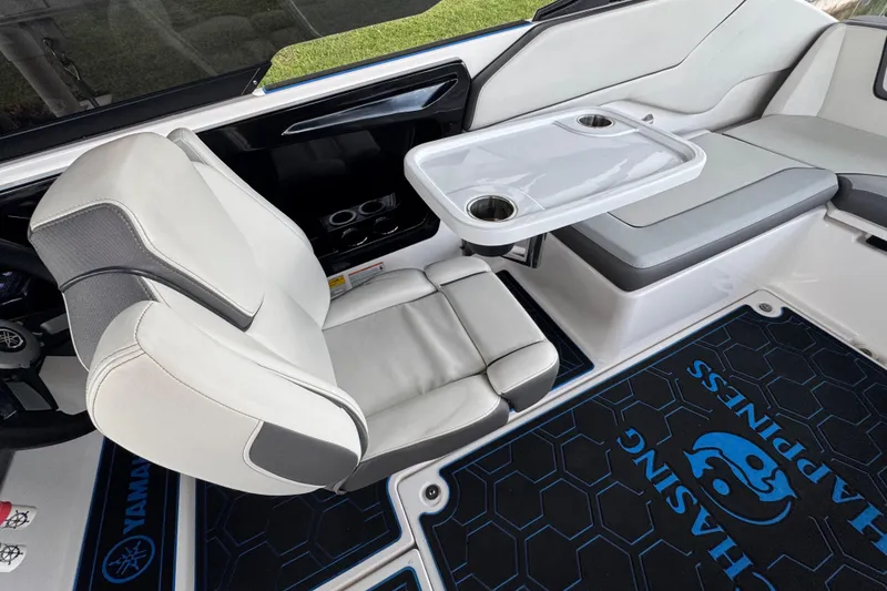 Slide: The Image of 2023 Yamaha Boats AR250 interior with seating and table, featuring modern design and comfort. - 20