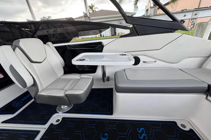 Slide: The Image of 2023 Yamaha Boats AR250 interior with seating and table, showcasing modern design and comfort. - 21