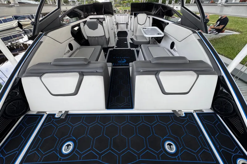 Slide: The Image of 2023 Yamaha Boats AR250 interior with modern seating and stylish flooring design. - 23