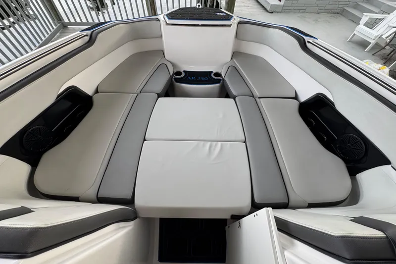 Slide: The Image of 2023 Yamaha Boats AR250 interior with spacious seating and modern design. - 24