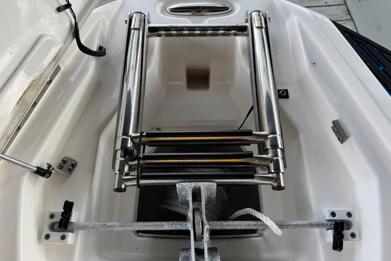Slide: The Image of 2023 Yamaha AR250 boat anchor compartment with stainless steel ladder and rope. - 26