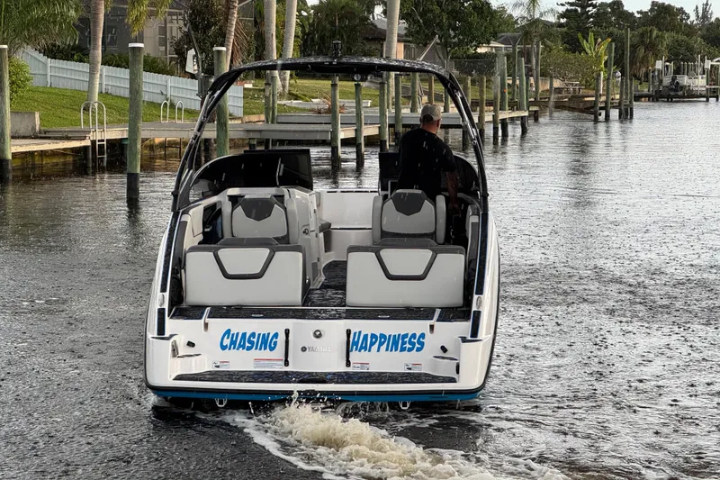 Slide: The Image of 2023 Yamaha Boats AR250 cruising on a scenic waterway, labeled "Chasing Happiness." - 7