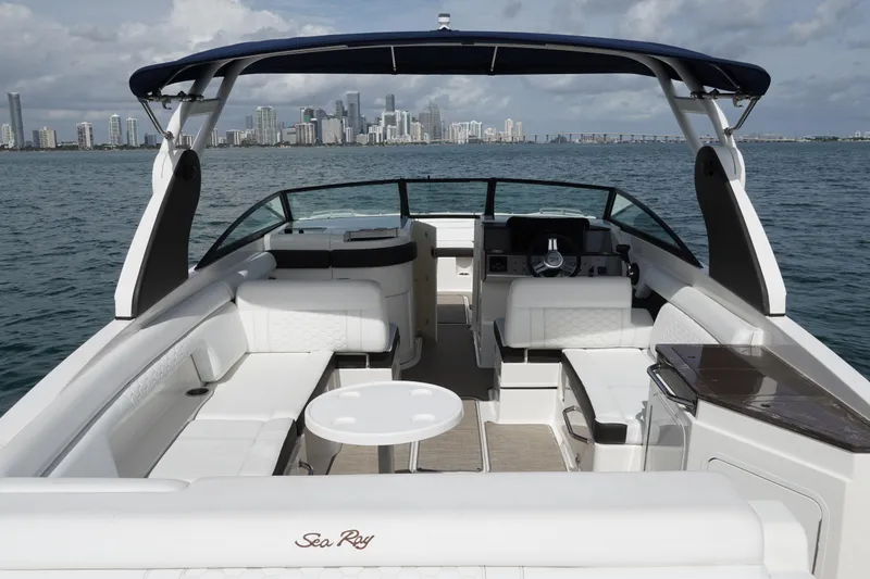 Slide: The Image of 2018 Sea Ray SDX 290 boat interior with city skyline in the background. - 10