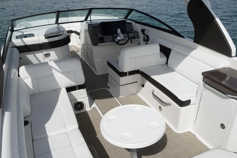 Slide: The Image of 2018 Sea Ray SDX 290 boat interior with luxurious white seating and modern dashboard. - 11