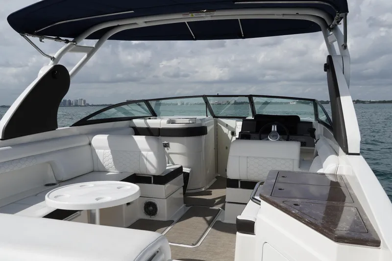 Slide: The Image of 2018 Sea Ray SDX 290 boat interior with luxurious seating and modern design on open water. - 12