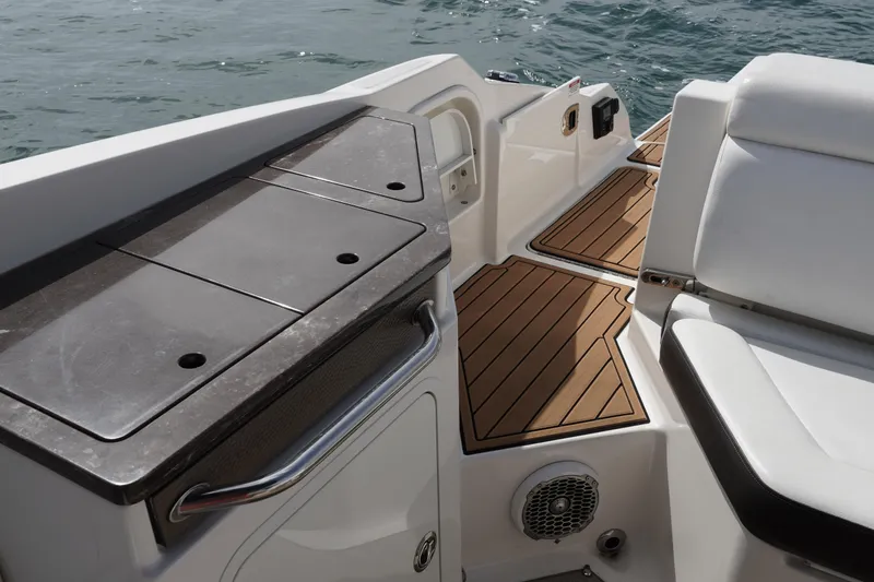 Slide: The Image of 2018 Sea Ray SDX 290 boat interior with teak flooring and seating. - 16