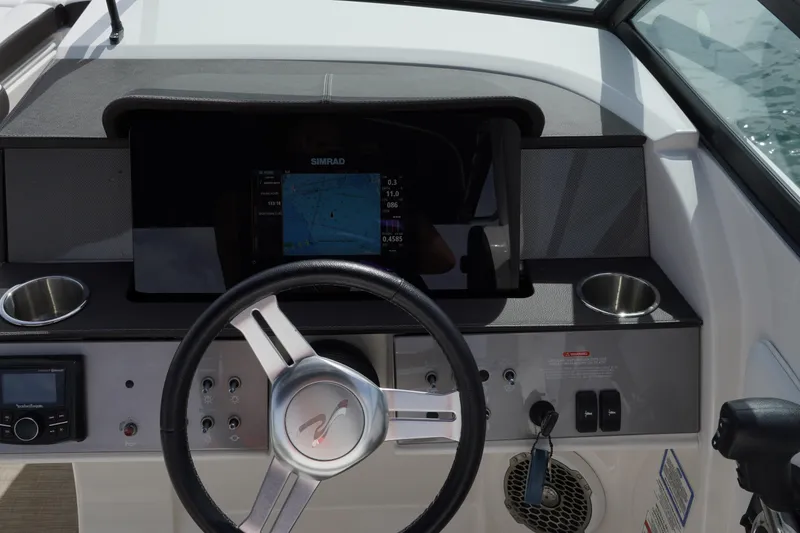 Slide: The Image of 2018 Sea Ray SDX 290 dashboard with steering wheel and navigation display. - 17