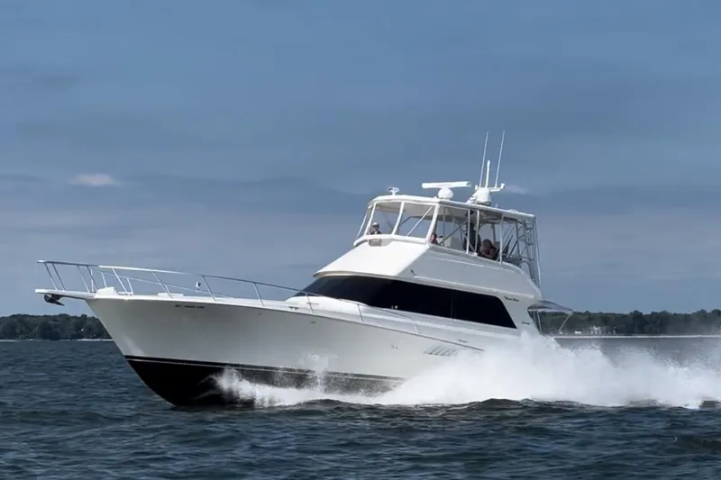 The Image of 1996 Viking 50 Convertible yacht cruising on open water, creating a dynamic wake. - 0