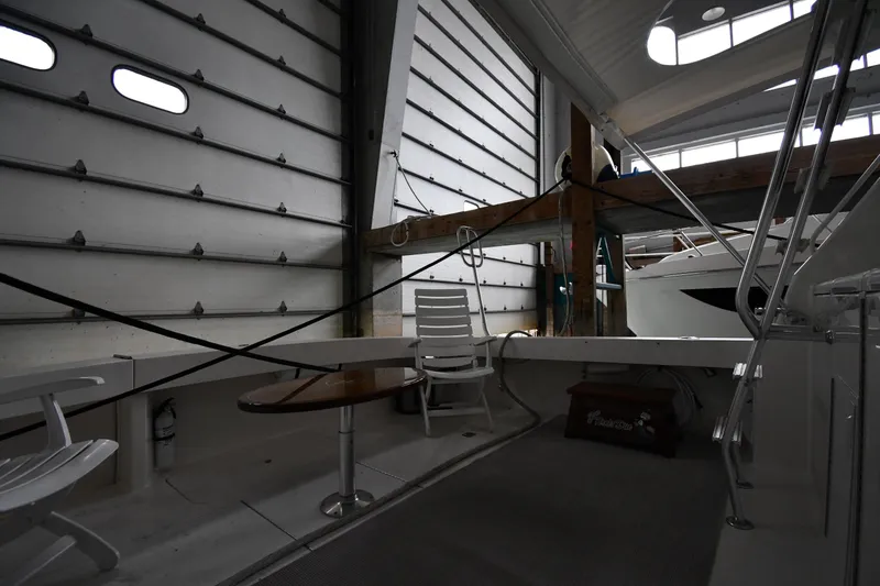 Slide: The Image of Interior of 1996 Viking 50 Convertible yacht in storage, featuring seating and table. - 11