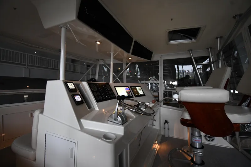 Slide: The Image of 1996 Viking 50 Convertible yacht helm with modern controls and comfortable seating. - 15