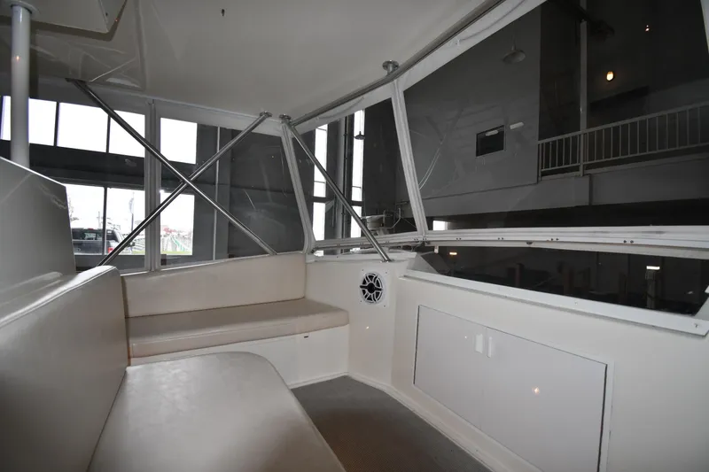 Slide: The Image of Interior of 1996 Viking 50 Convertible yacht with seating and windows. - 19